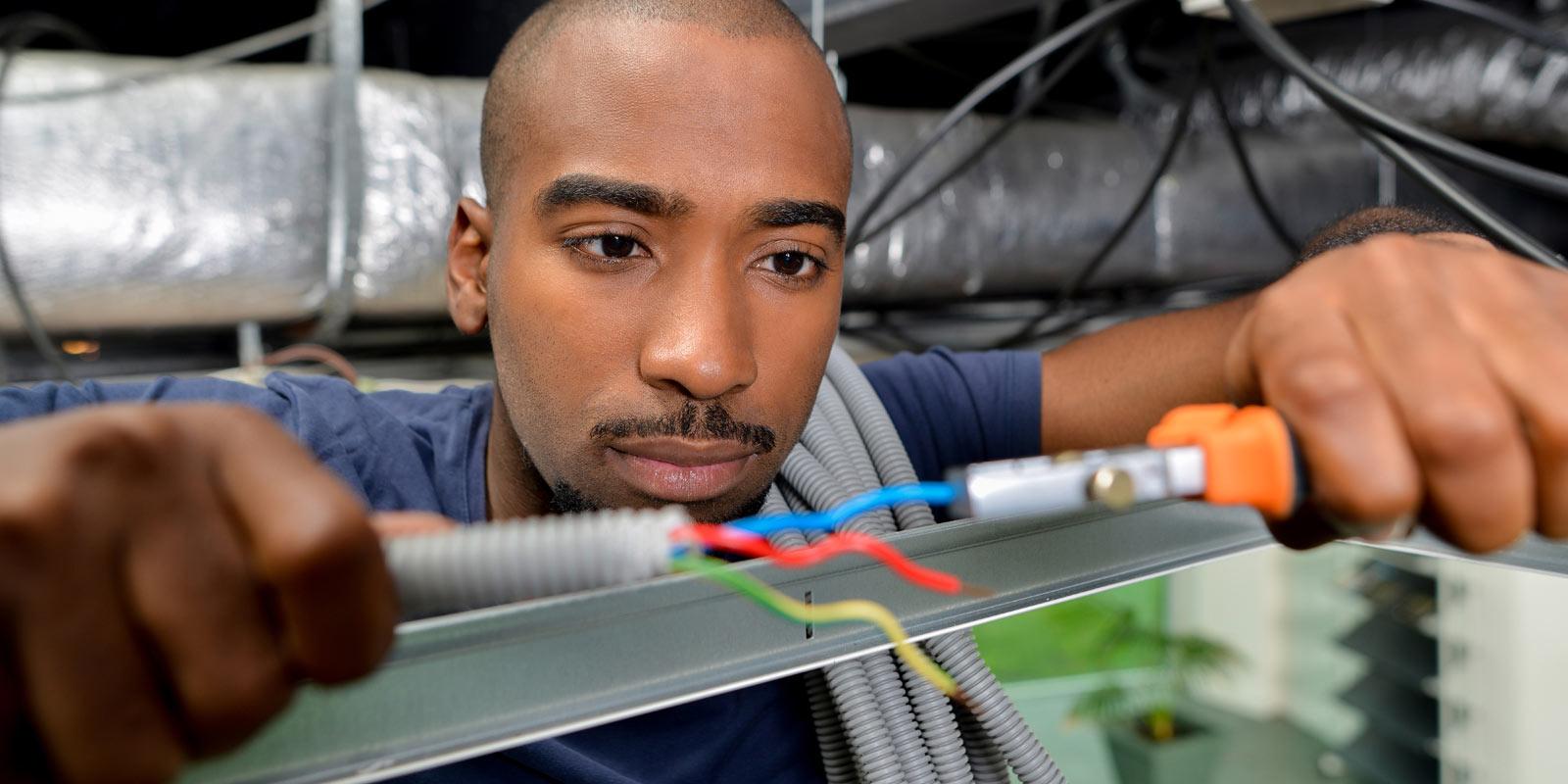 Man works on electrical project.