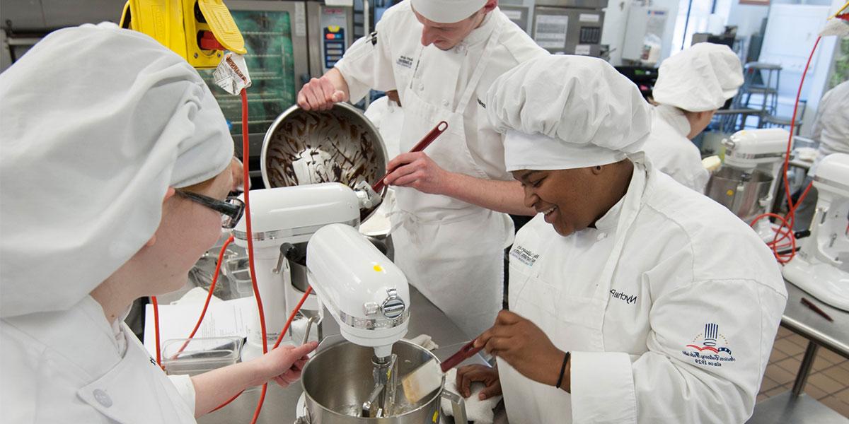 Culinary students work in commercial kitchen