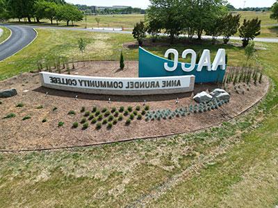 Aerial view of AACC sign at entrance of campus